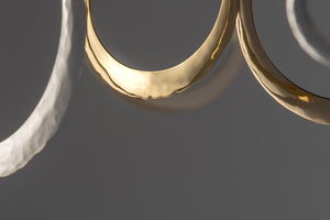 Hanging selection of gold and silver hand forged hoop earrings by iihoops isaac ibbotson