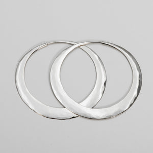 Pair of ii hoop earrings hand forged sterling silver hoop earrings. Made in Nelson, New Zealand our unique hammered design is lightweight and lasts a lifetime.