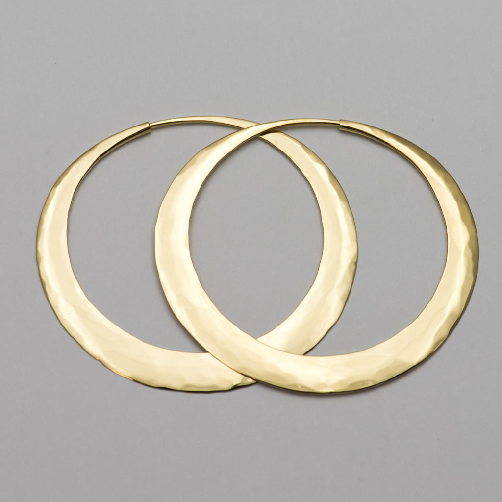 Our hand forged hoop earrings made to order in your choice of 9ct, 18ct or 22ct gold in in Nelson , New Zealand . Designed by Isaac Ibbotson in 2001 the hoops are immediately recognizable as they 'catch the light' with their unique hammered surface. Made of either sterling silver or solid gold they are lightweight enough to wear everyday yet strong enough to last a lifetime.